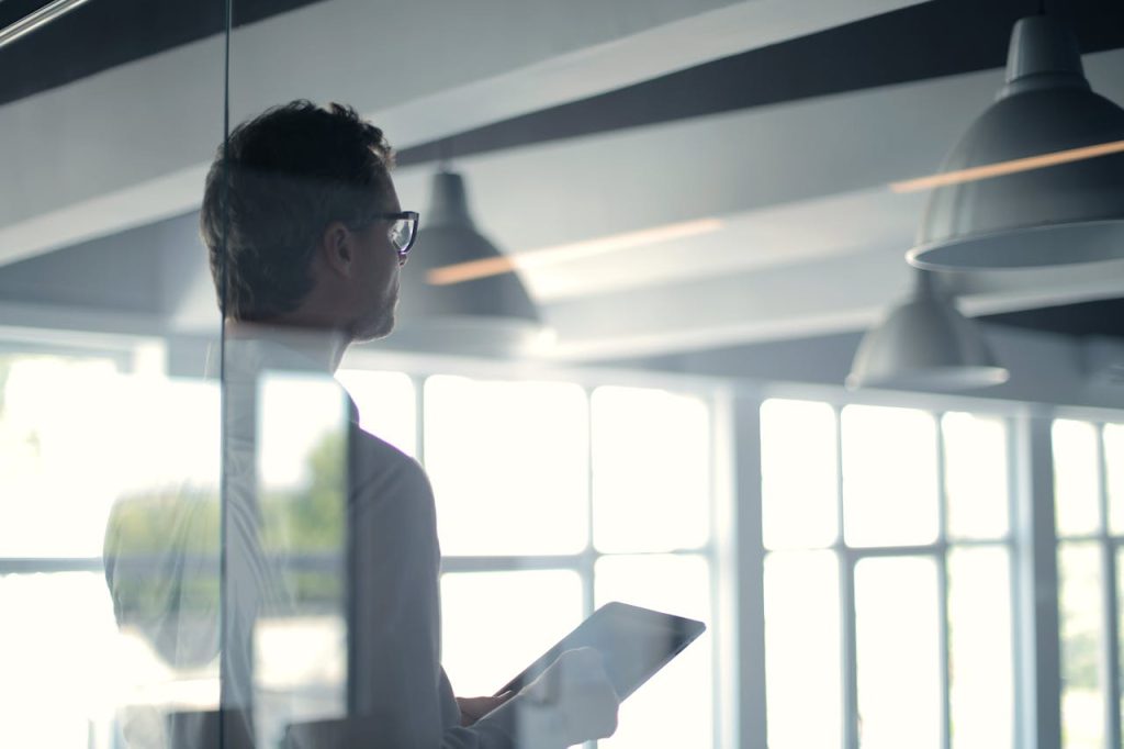 Man Reading Financial News on a Tablet.